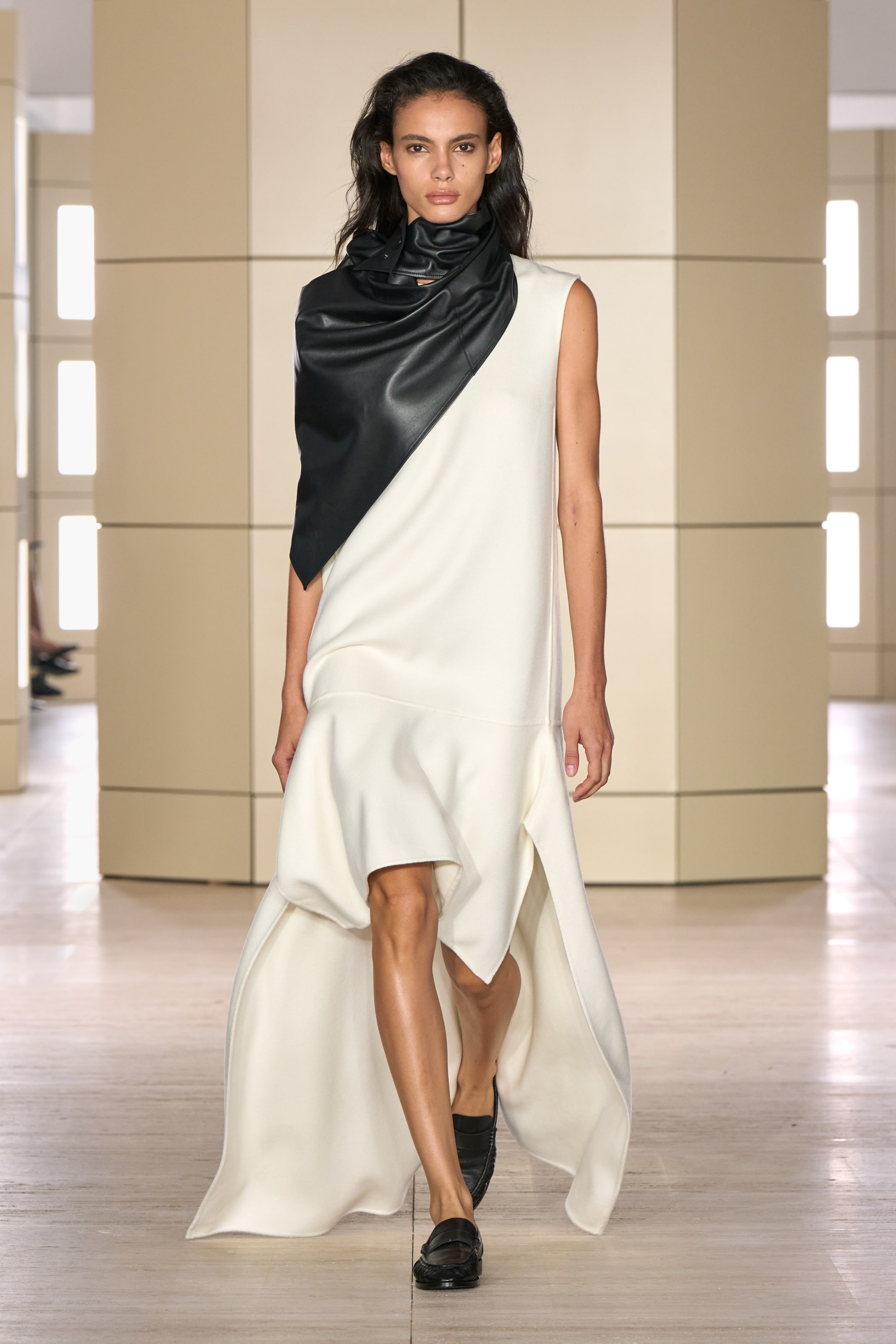 Person walking on a runway wearing white
