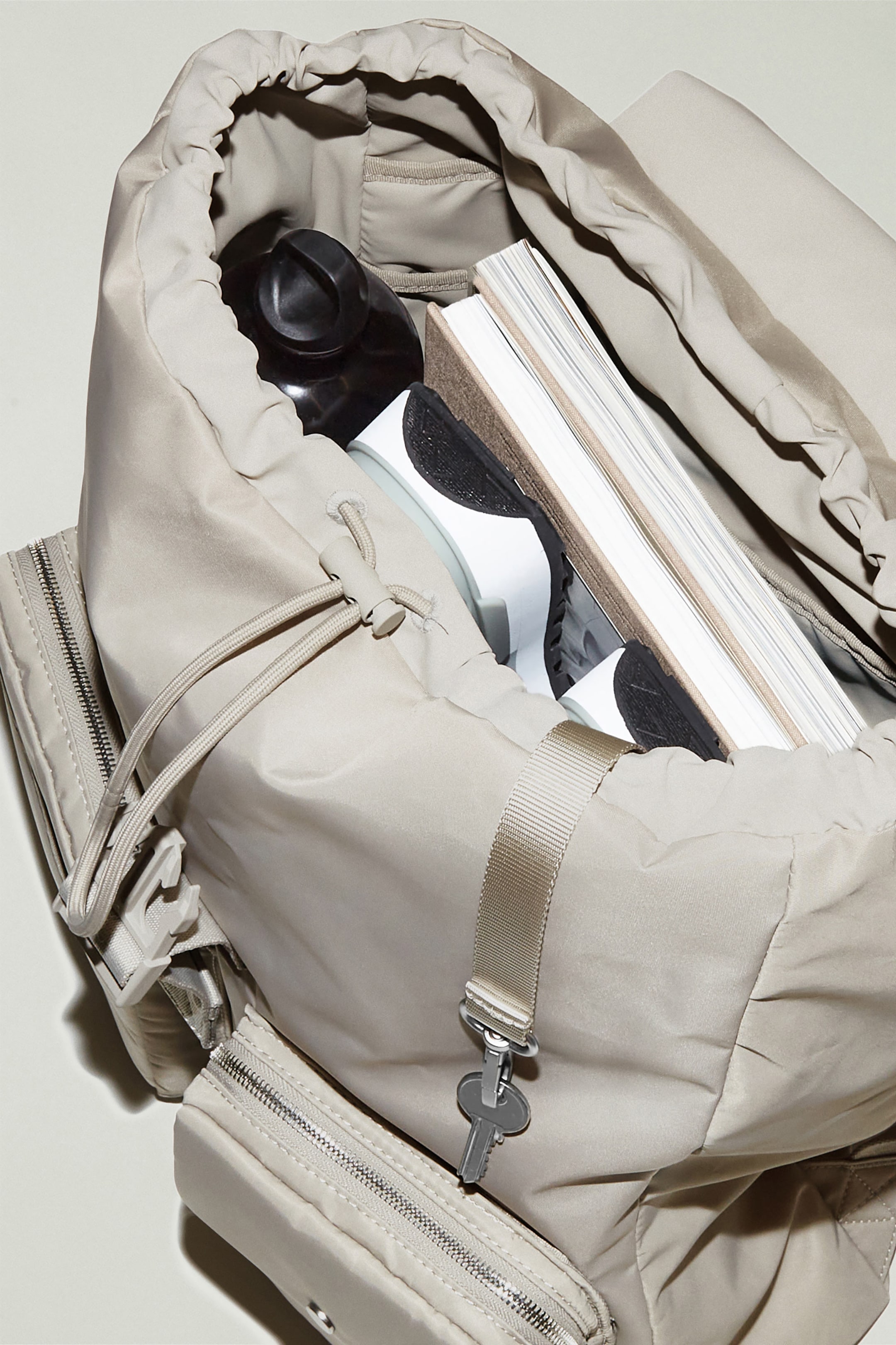 Beige backpack with drawstring closing