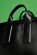Placeholder for: Up close shot of cactus leather black bag handle