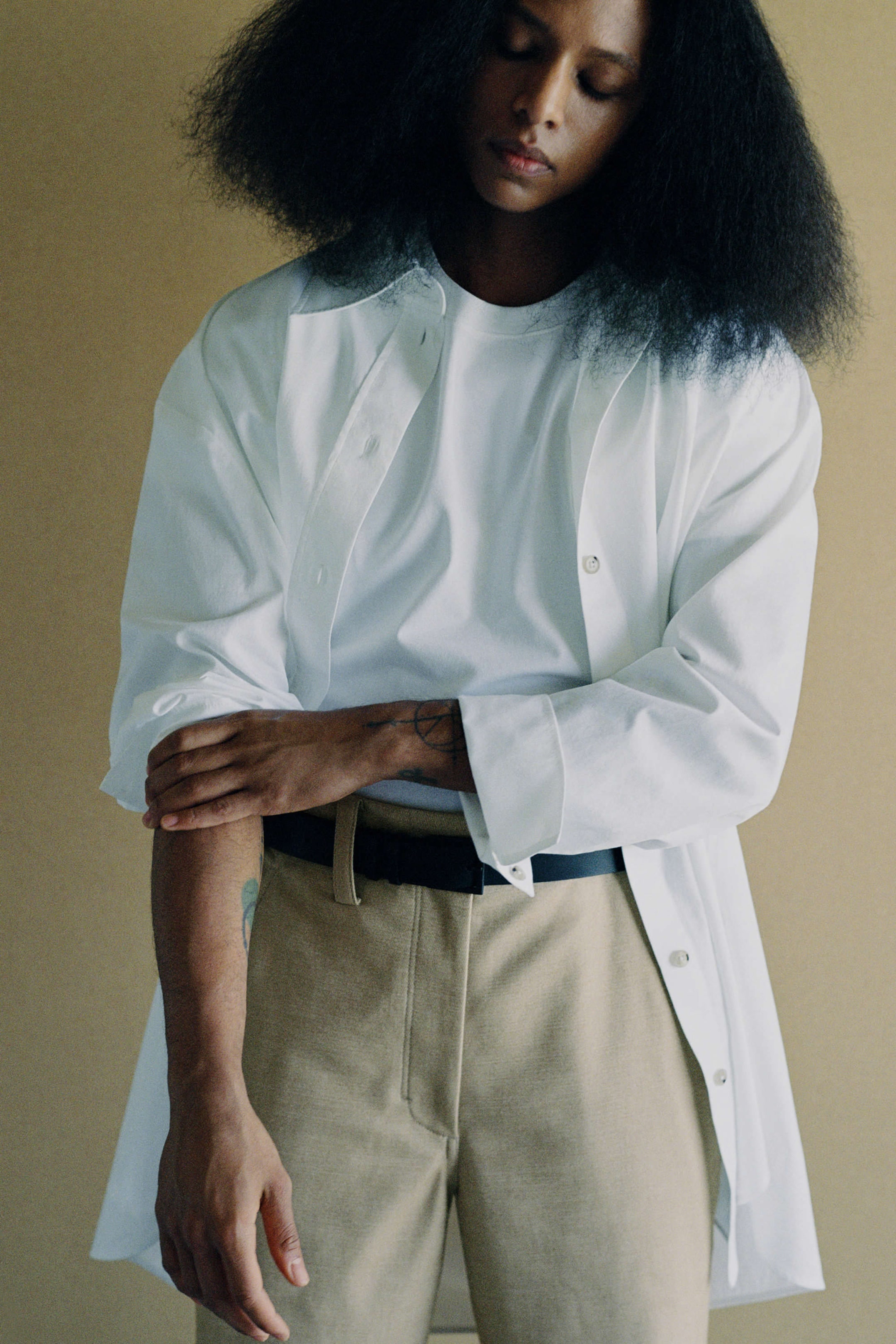 Janaya wears shirt, trousers and belt by COS.
