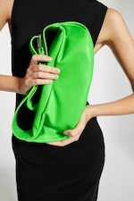 Placeholder for: Woman holding cactus green sling bag made with Desserto material