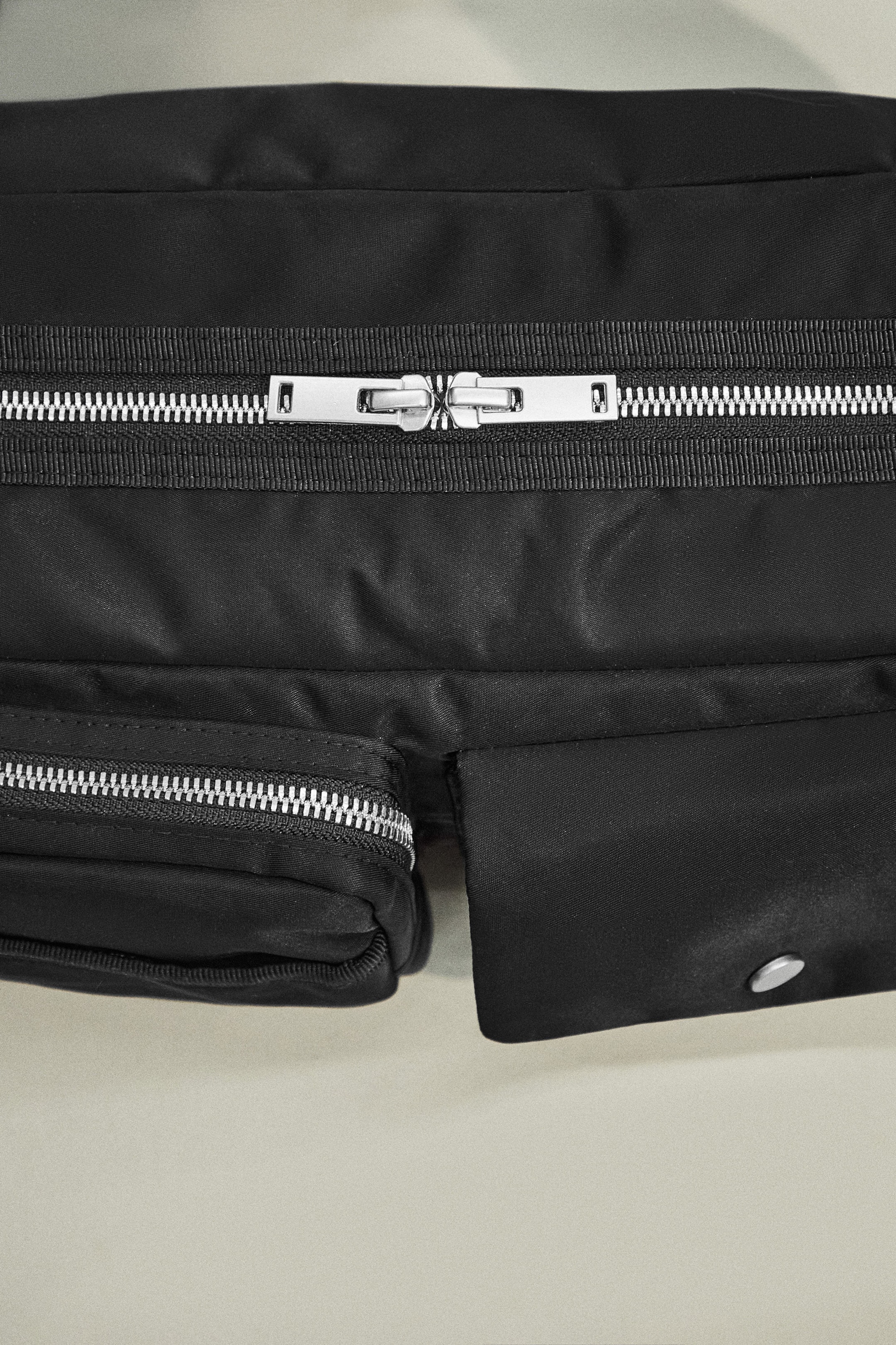Black nylon bag with silver zip