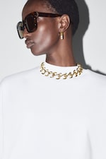 Placeholder for: Woman wearing white tee with gold necklace