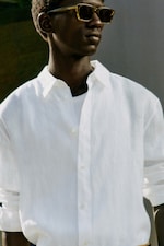 Placeholder for: Man wearing sunglasses and white linen shirt