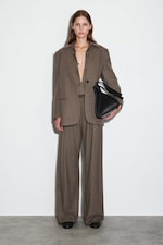 Placeholder for: person wearing brown wide leg trousers