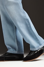 Placeholder for: Person wearing jeans and black trainers