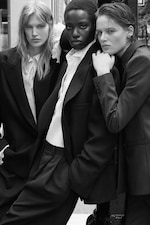 Placeholder for: Three individuals in suits pose confidently in a black-and-white photograph, exuding style and sophistication.