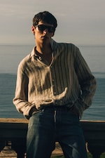 Placeholder for: Man in sunglasses waering a striped linen shirt