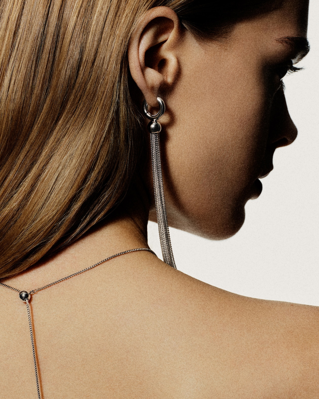 person wearing earring and necklace