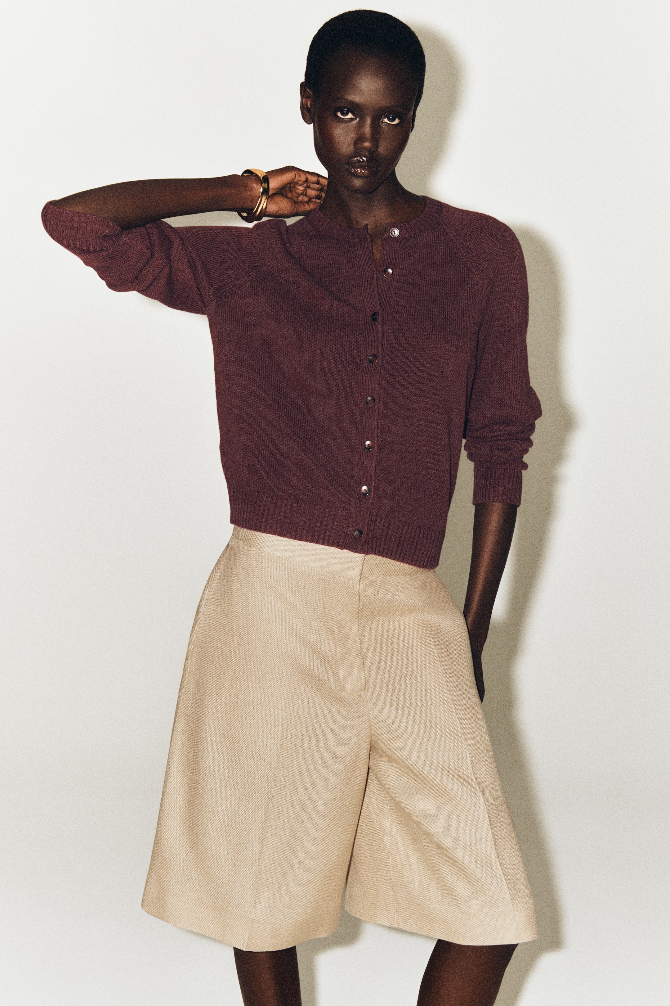 person wearing knitwear and linen shorts