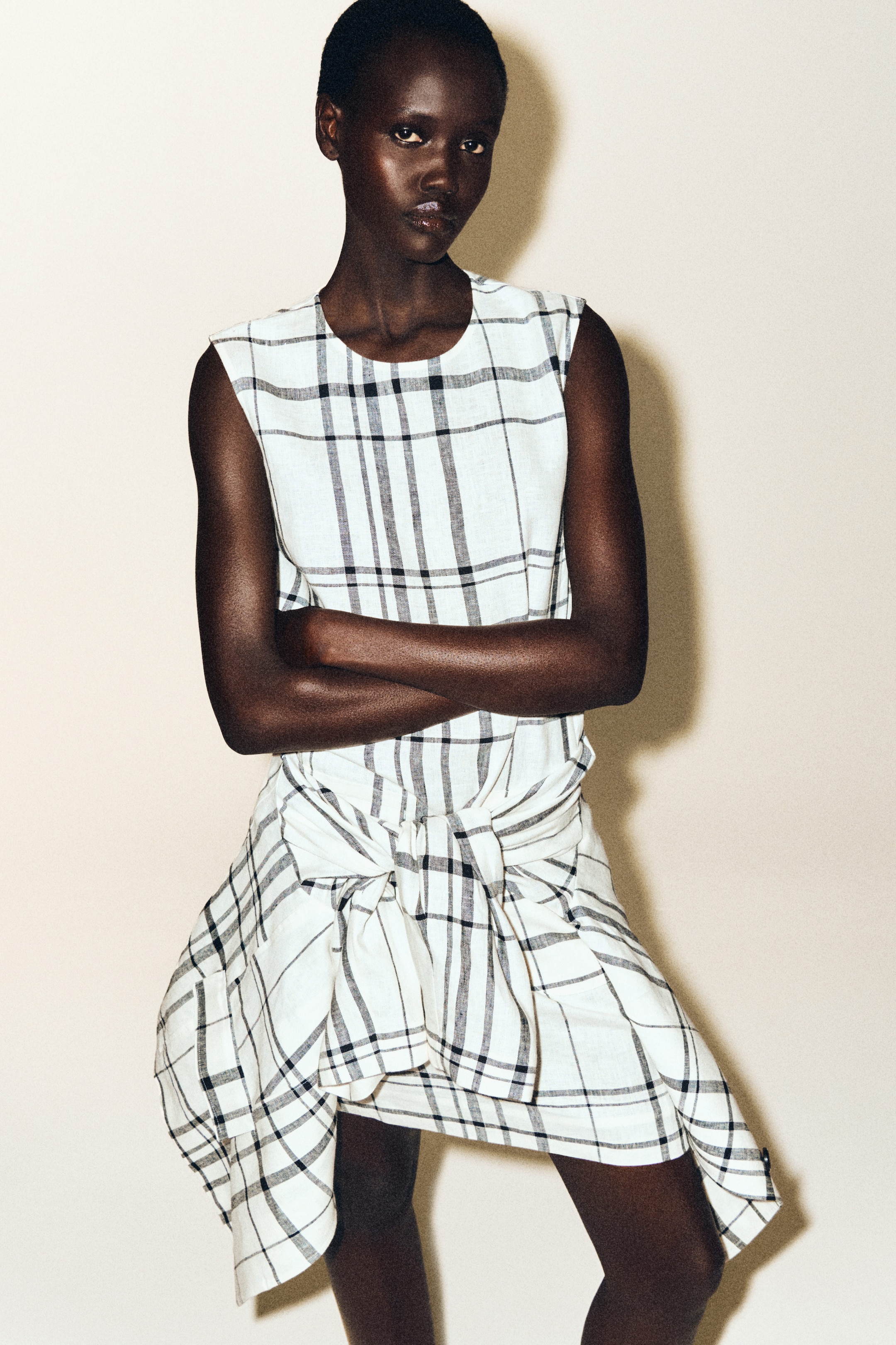 Person wearing white linen dress with stripes