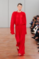 Placeholder for: woman wearing red pleated blouse and skirt