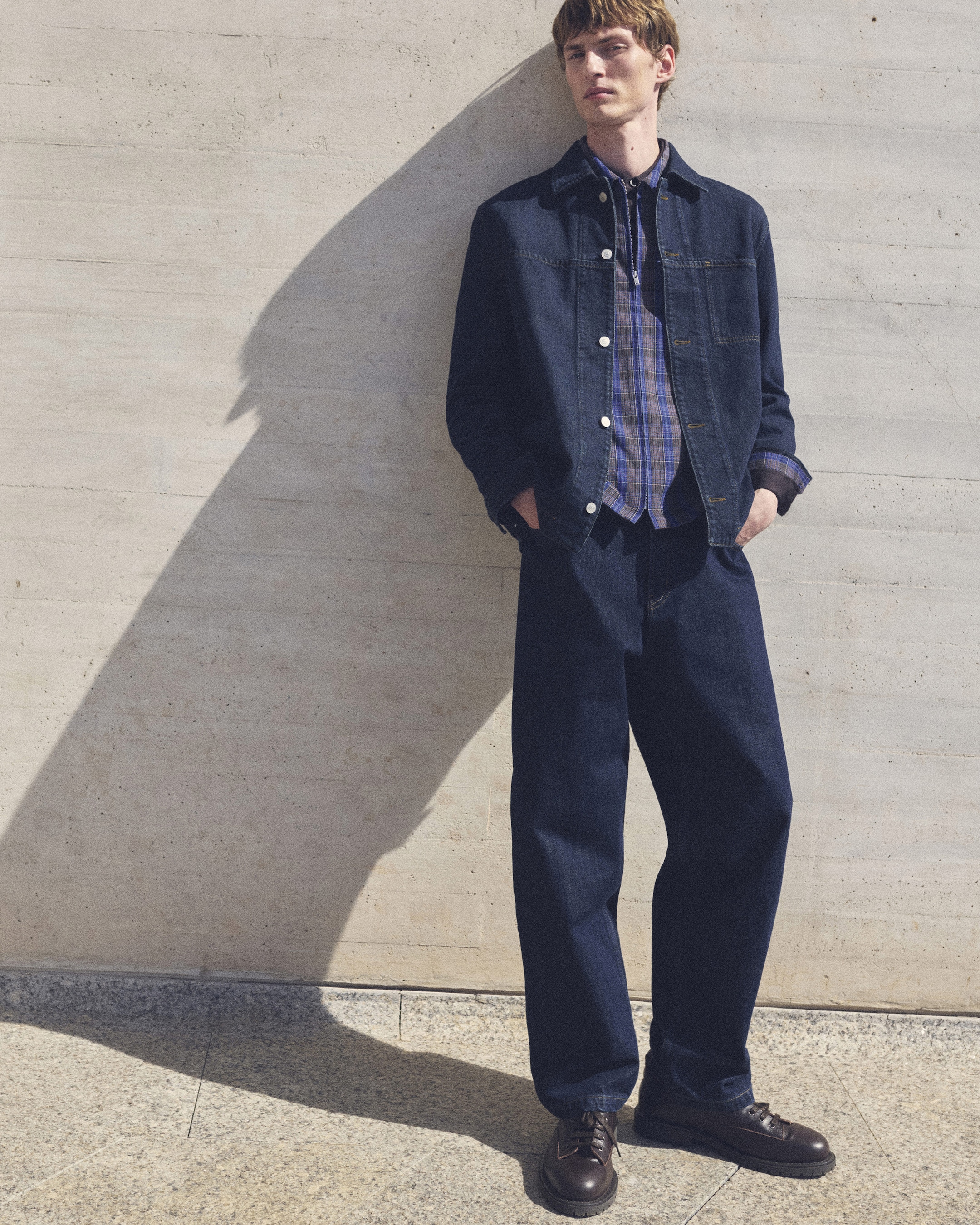 Man in a denim jacket and check shirt