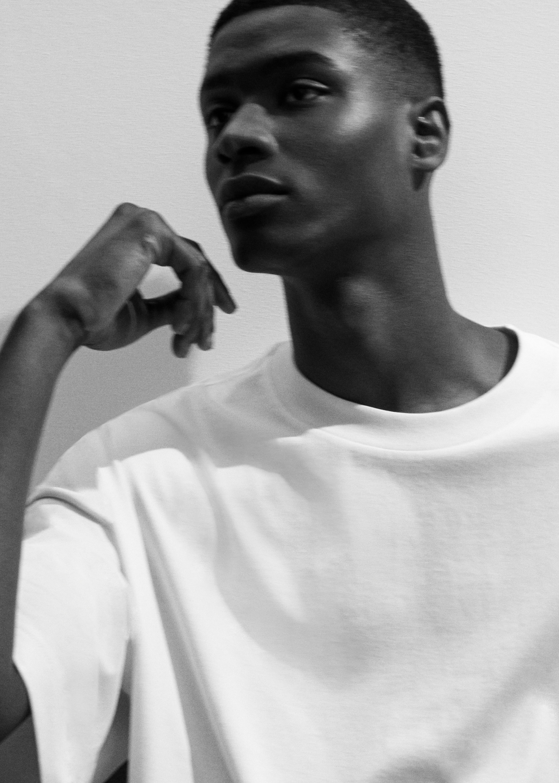 B&W Photo of man in white oversized t shirt