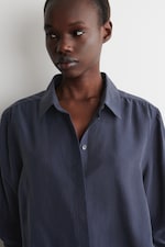 Placeholder for: woman in navy silkk shirt close up