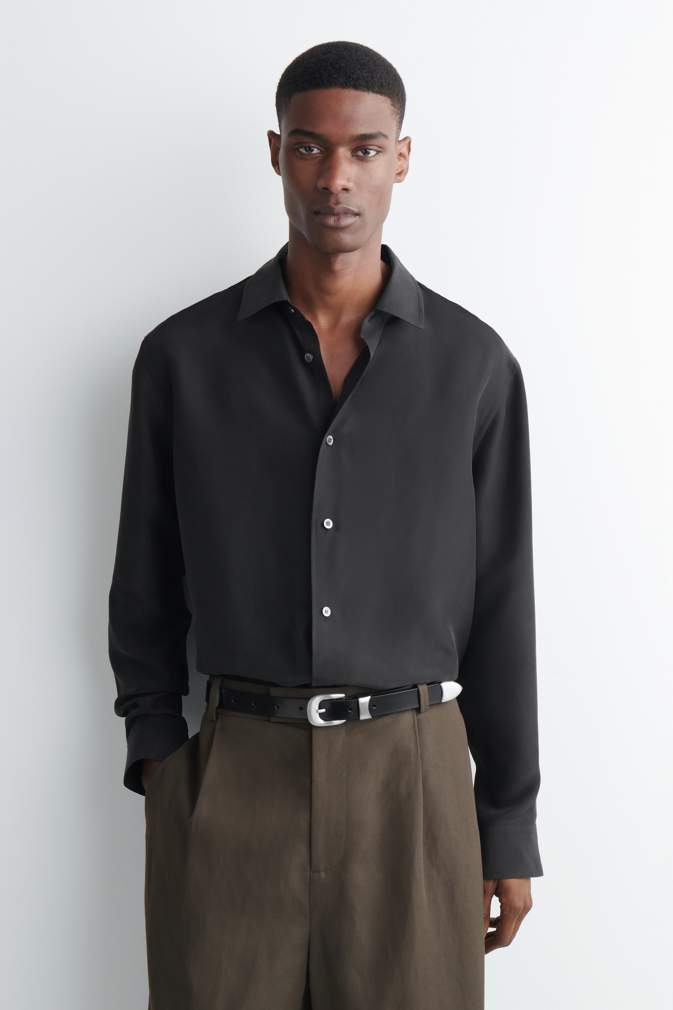 man in longsleeve black silk shirt