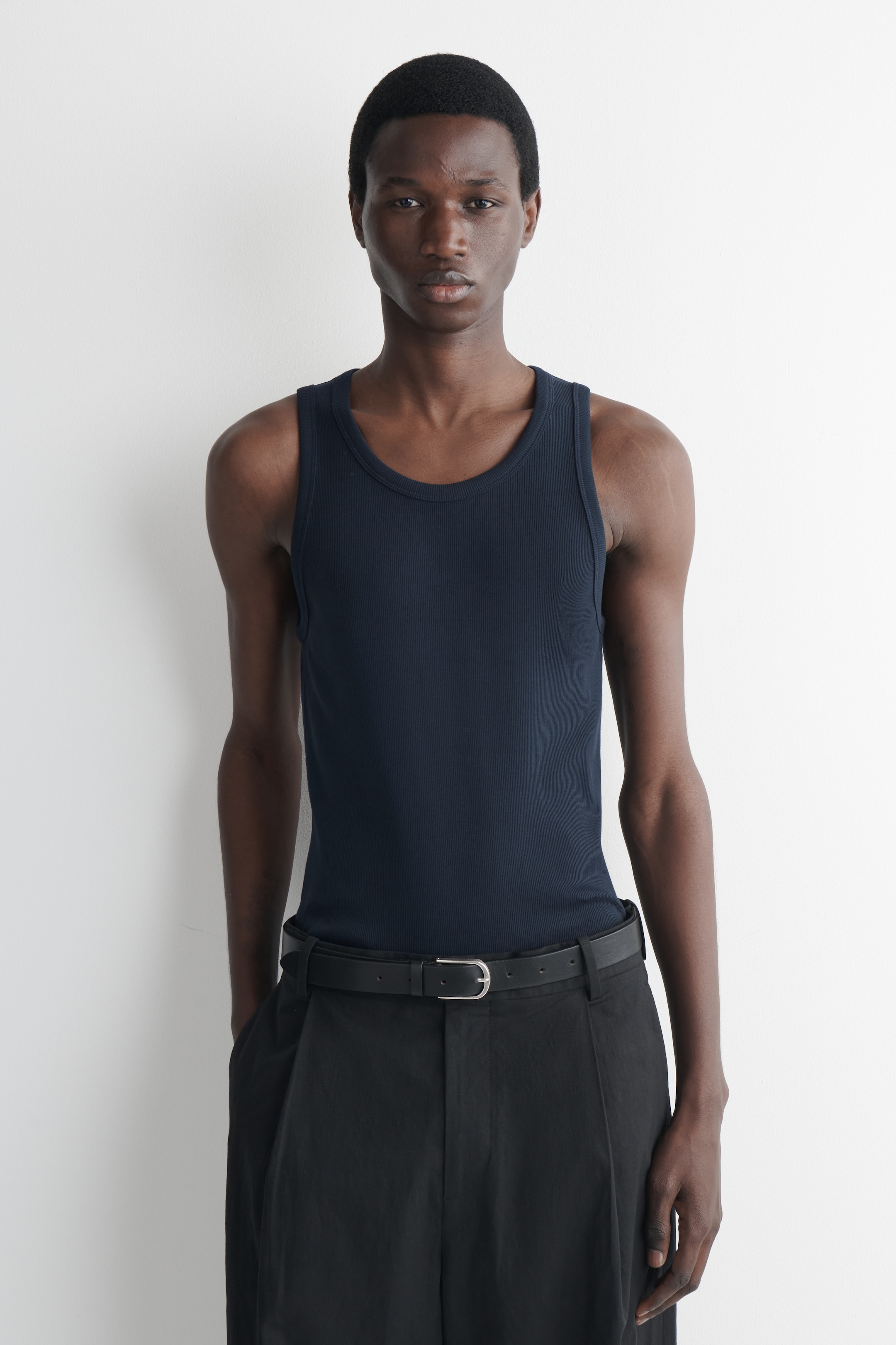 man wearing navy vest top
