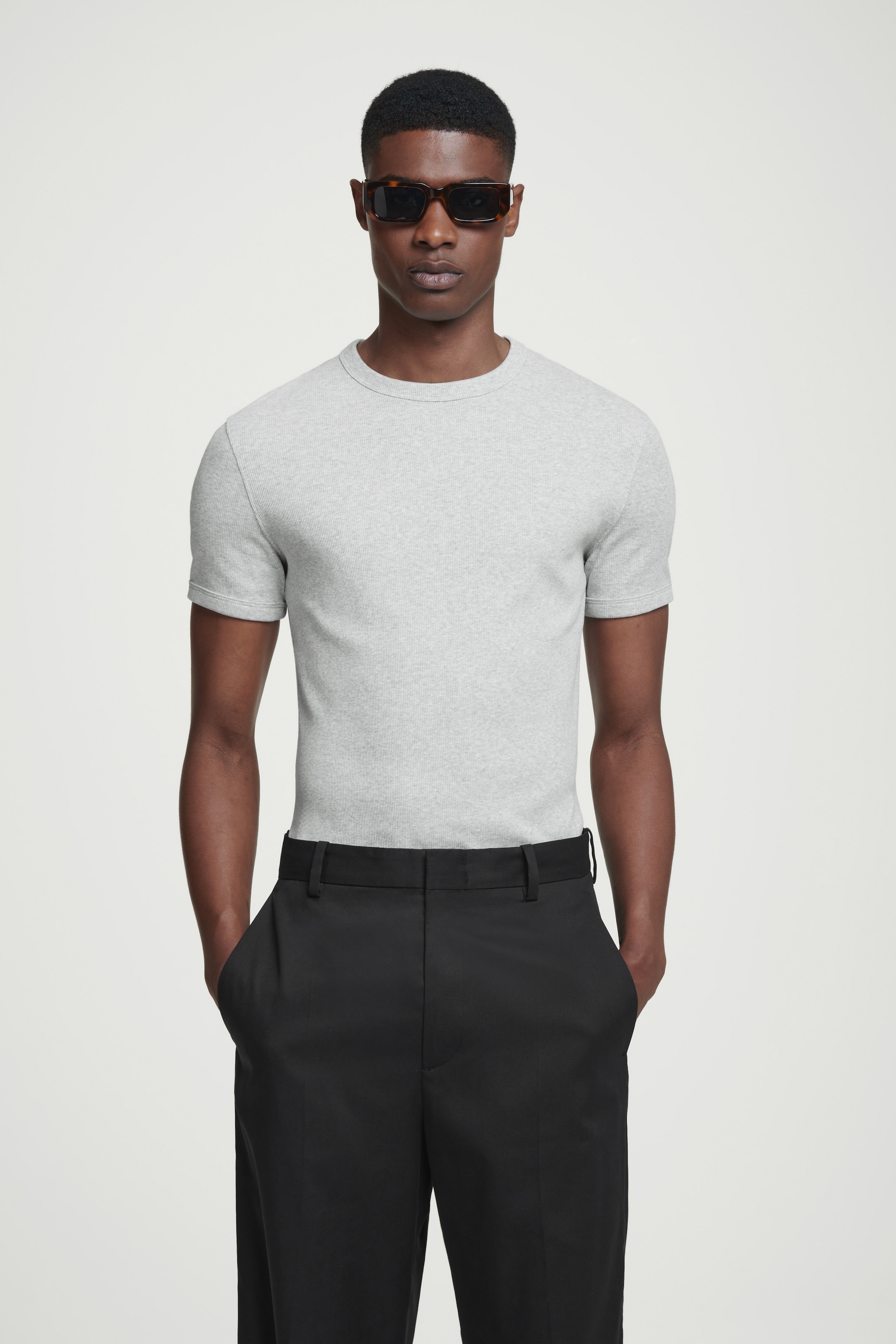 Man in grey top and black trousers