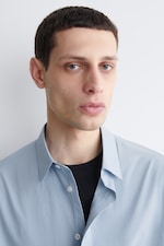 Placeholder for: model wearing a light blue shirt over a black t-shirt