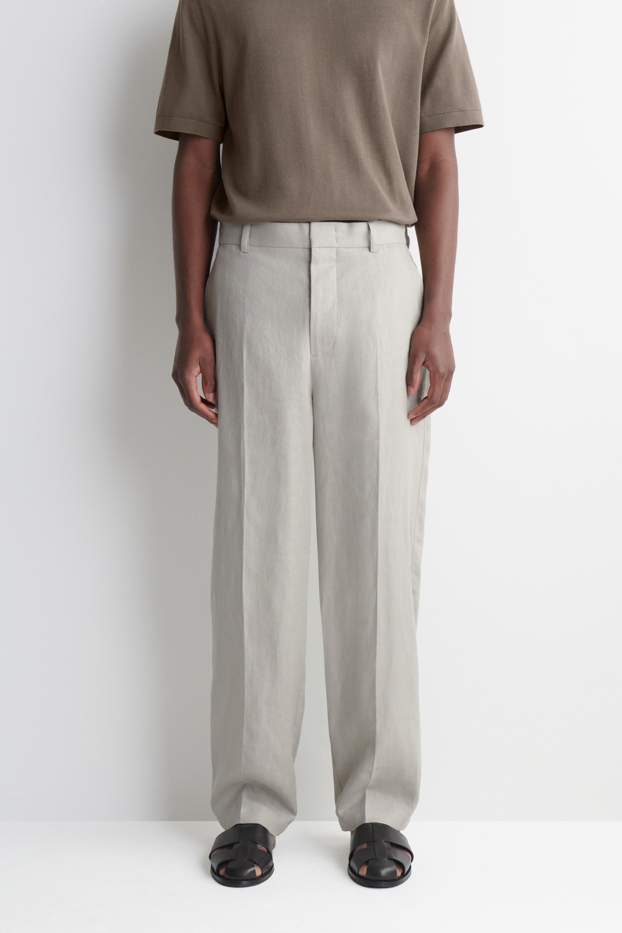 cropped image of man in linen straight leg trousers