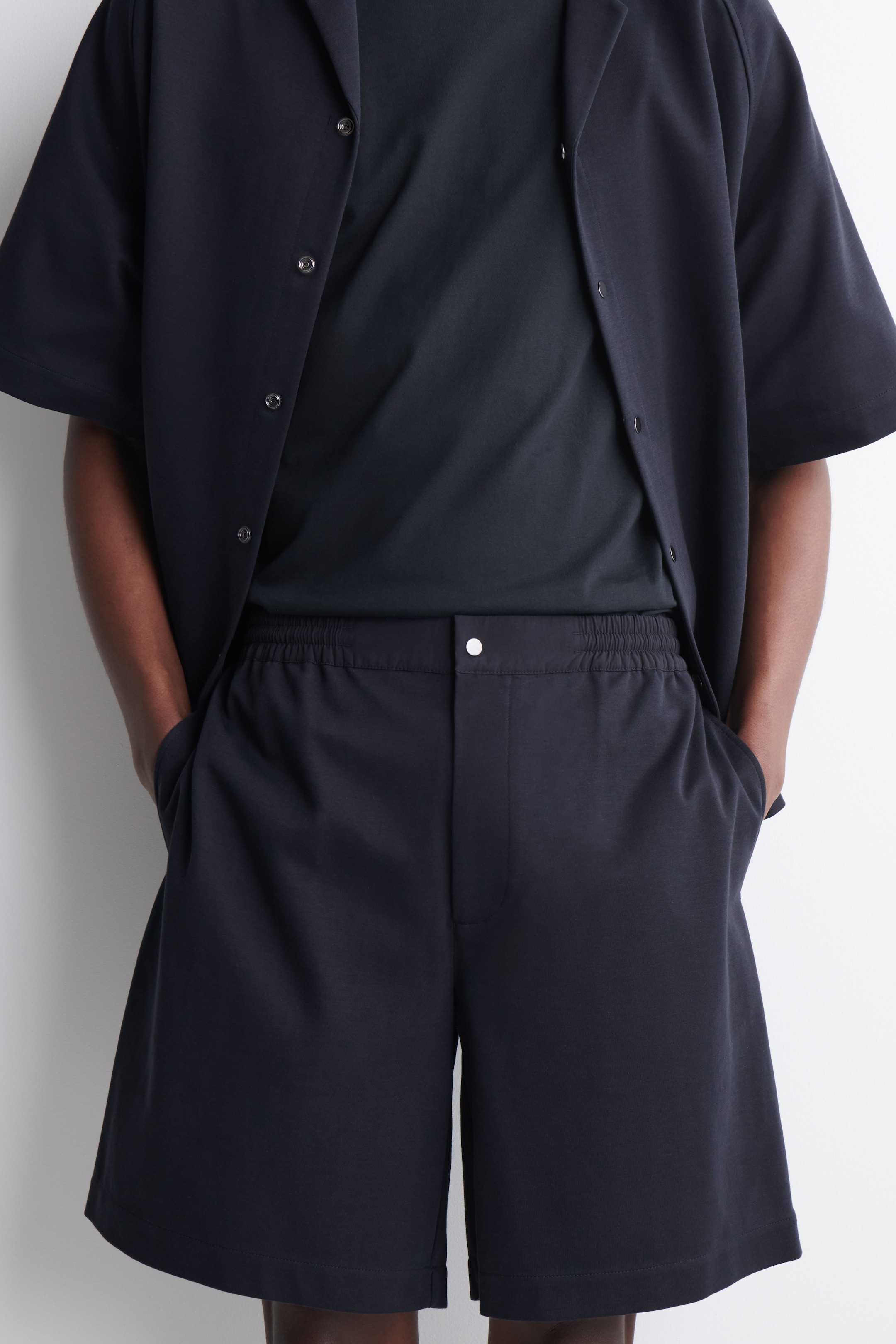 Cropped image of cotton navy shorts with elasticated waist