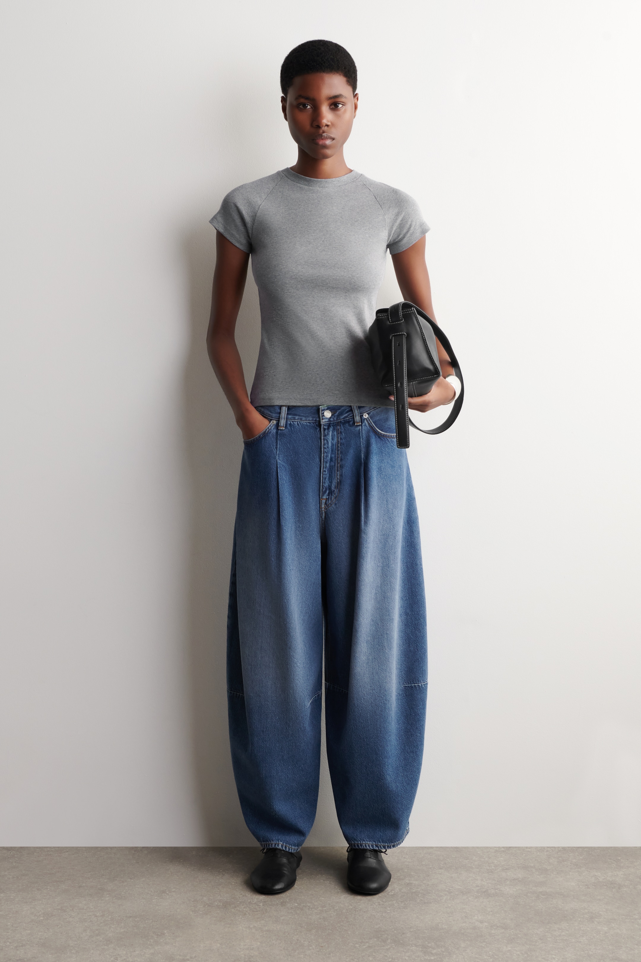 woman in barrel leg jeans