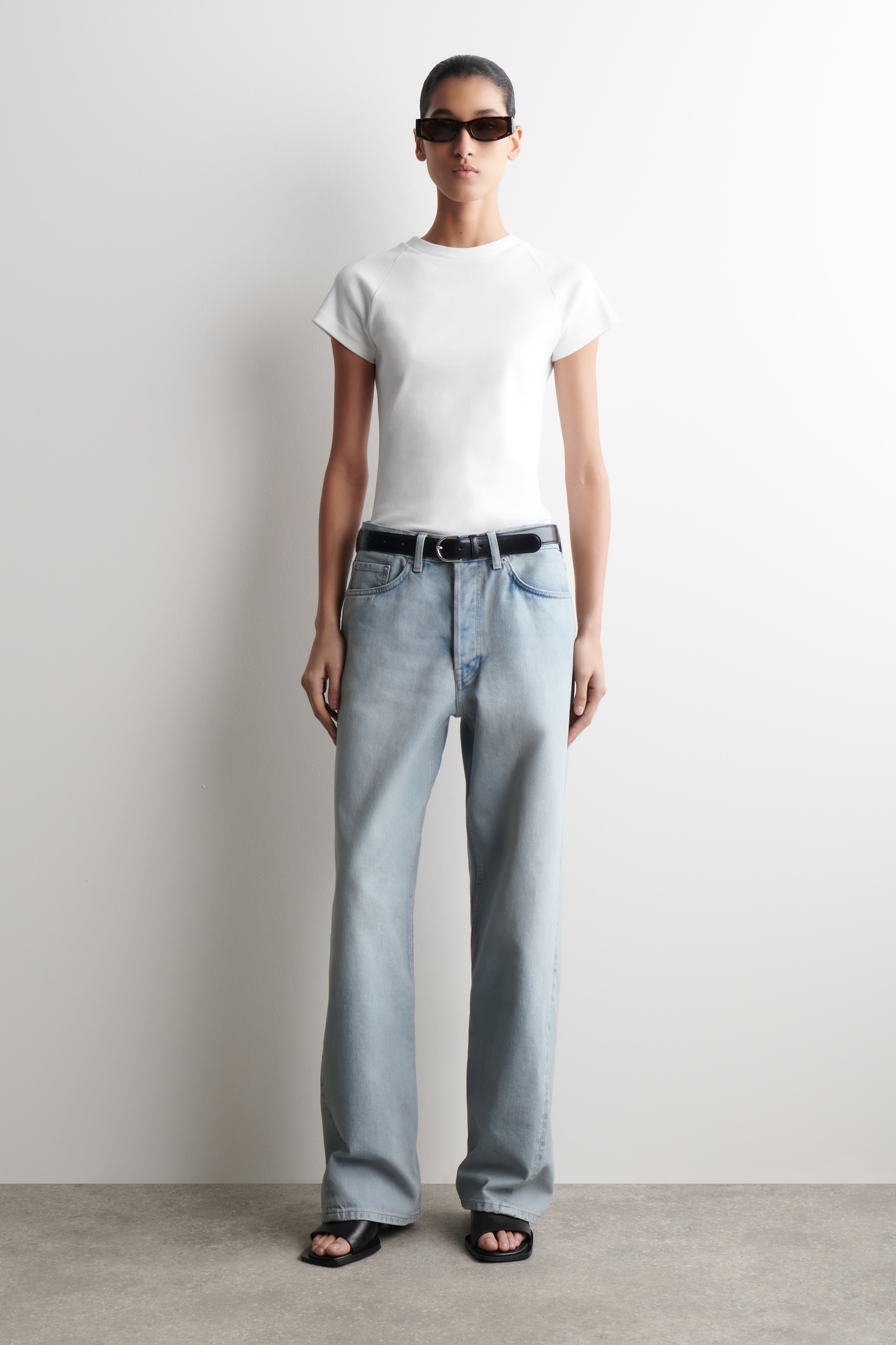 woman in white t-shirt and blue jeans