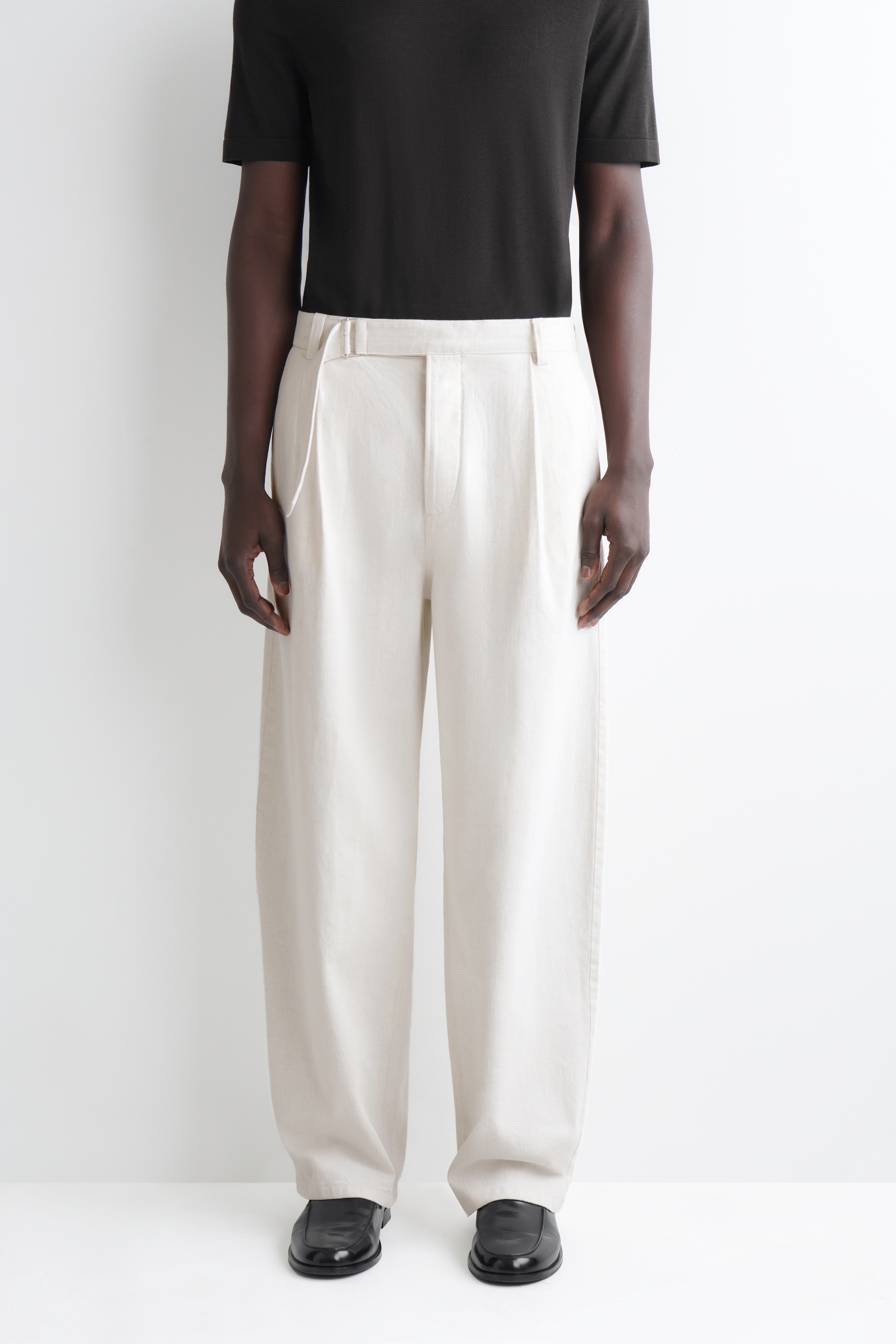 man in relaxed fit denim jeans in white