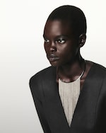 Placeholder for: Person wearing black top and silver necklace