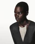 Placeholder for: PERSON WEARING SILVER NECKLACE AND black blazer