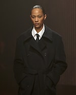 Placeholder for: Women wears black coat, white shirt and black tie
