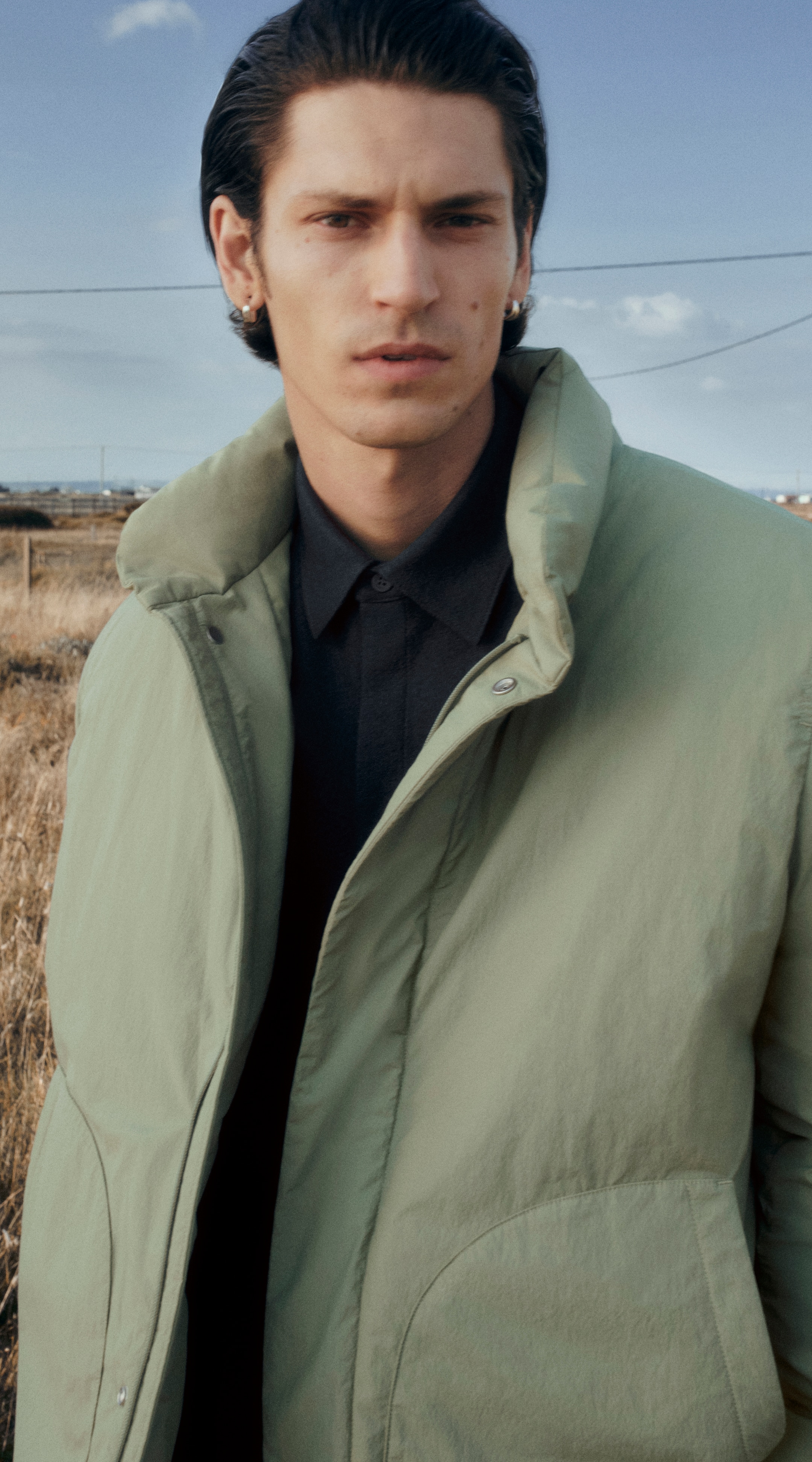 Man wearing light green puffer coat