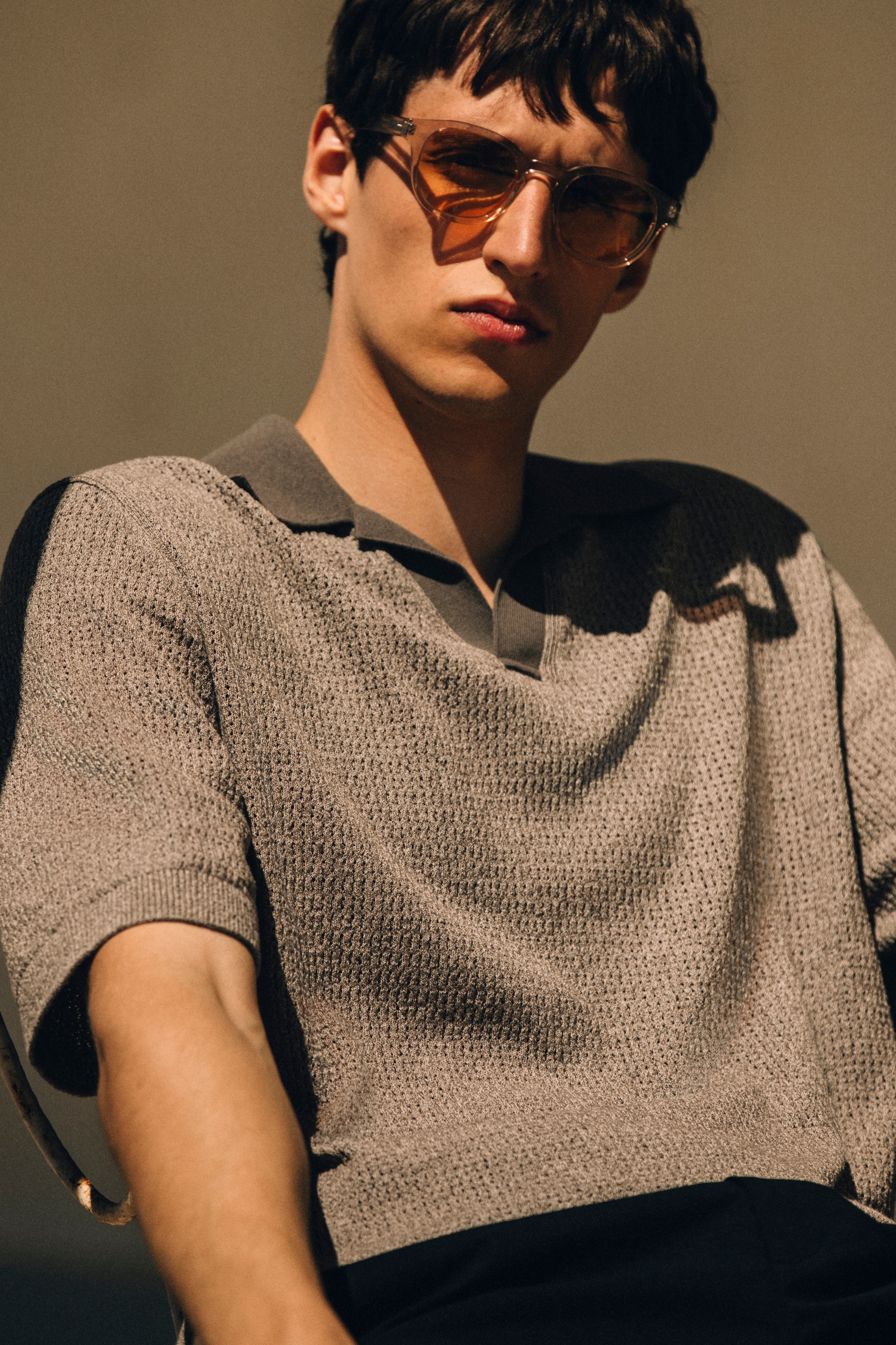 cropped photo of a man in sunglasses and knit polo shirt