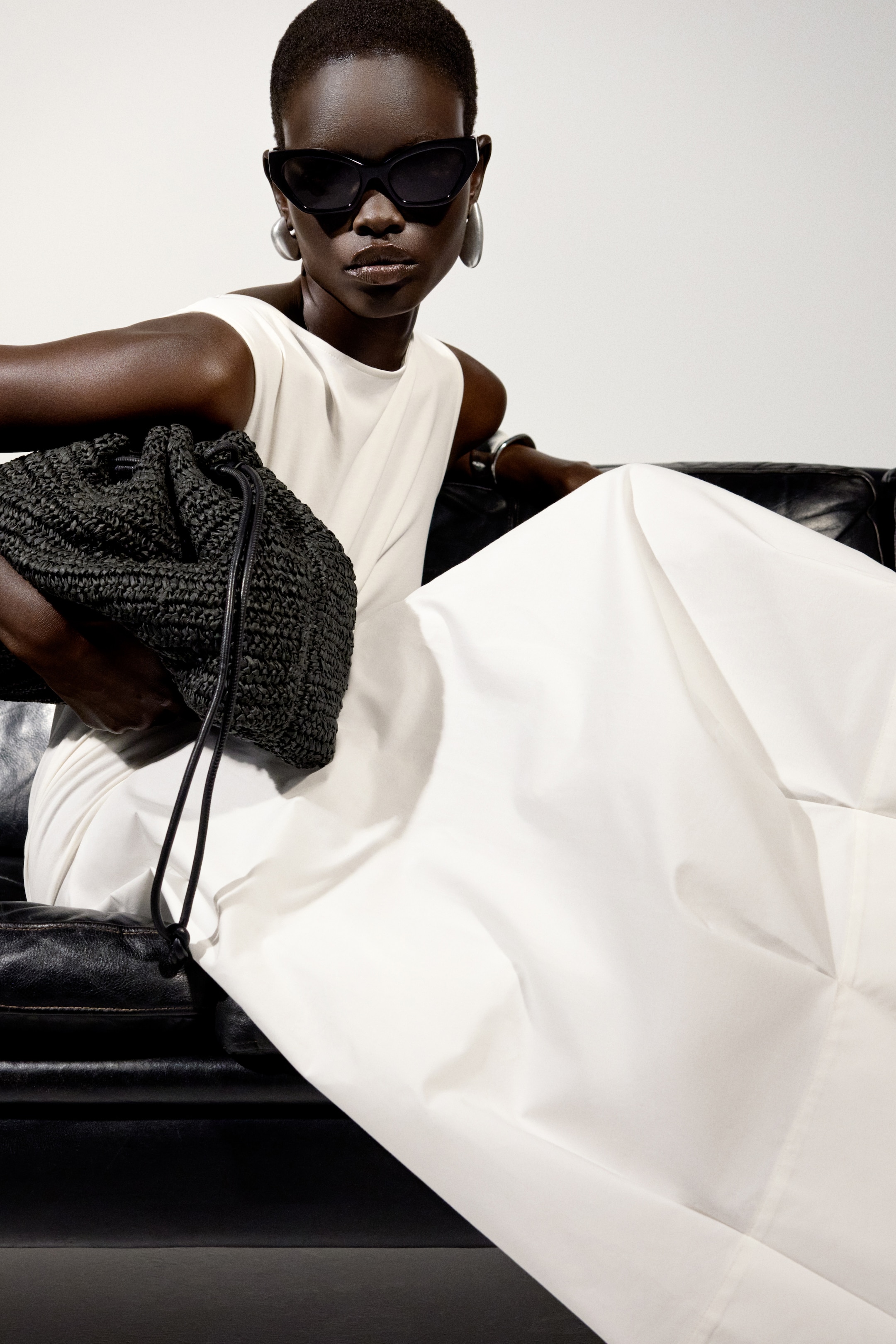 woman in white dress bag and sunglasses