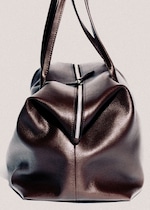 Placeholder for: Brown leather duffel bag with textured surface, prominent zipper, and two handles, positioned upright against a plain background.