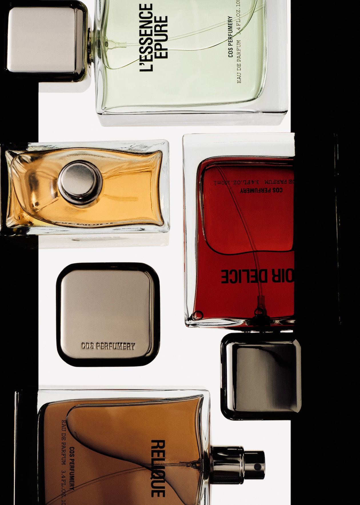 An arrangement of various perfume bottles in different colors, with visible labels.