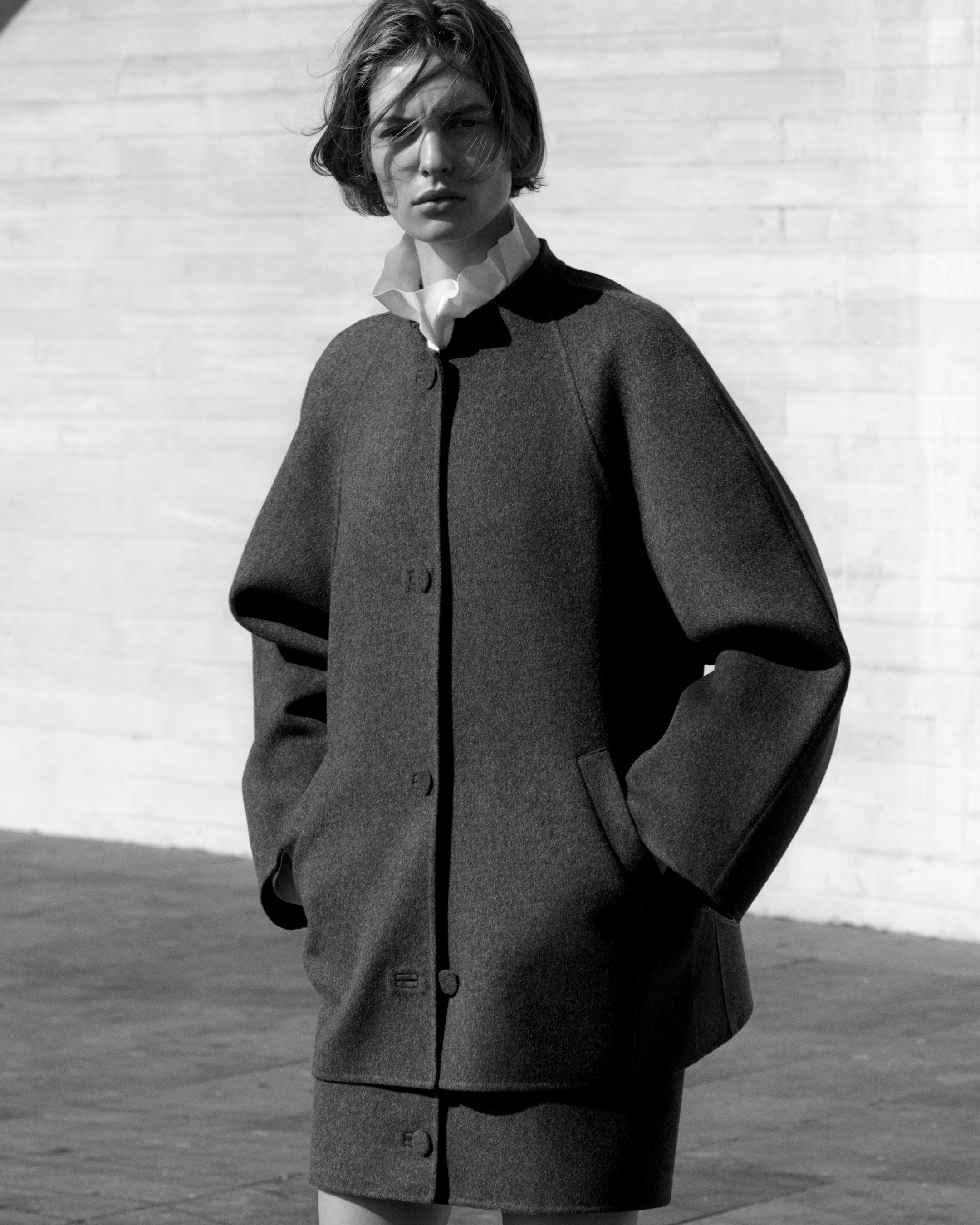 Person wearing grey wool jacket