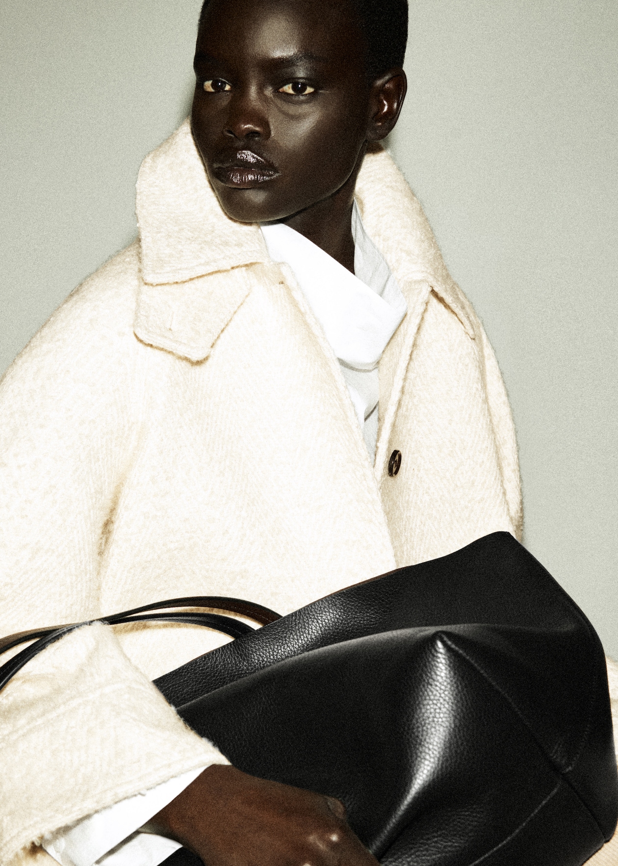 woman in coat holding bag