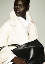 Placeholder for: woman in coat holding bag