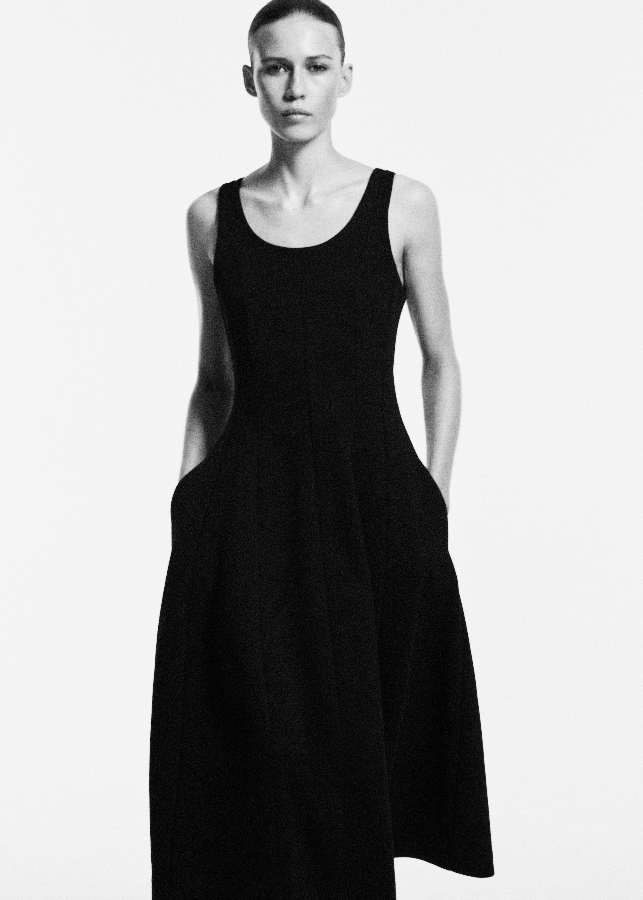 woman in black sleeveless midi dress