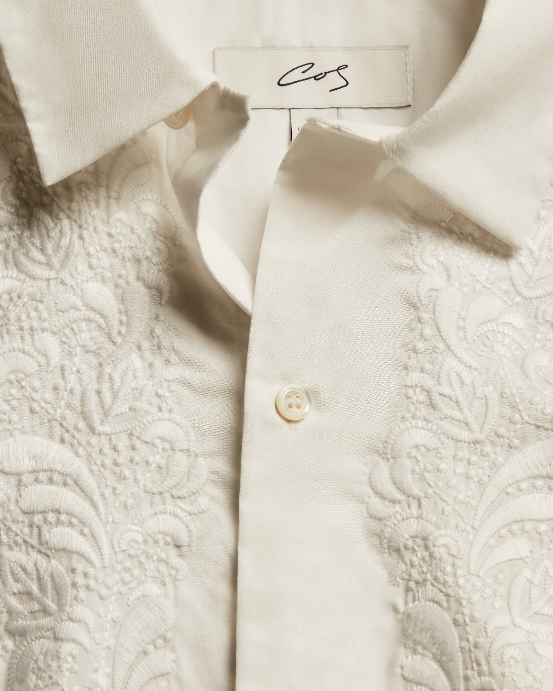Close up of cream broiderie white blouse