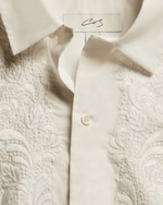 Placeholder for: Close up of cream broiderie white blouse