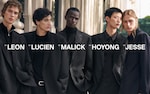 Placeholder for: Five individuals in stylish black suits stand close together outdoors, with names displayed prominently over each person.