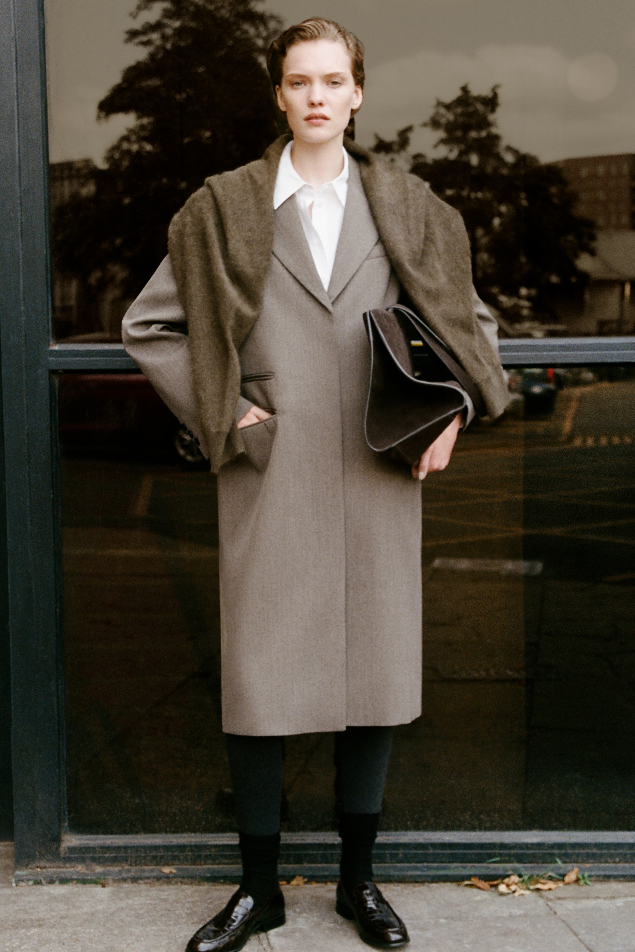 Lady in wool jacket with belt and black flats