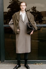 Placeholder for: Lady in wool jacket with belt and black flats