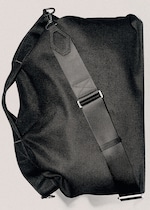 Placeholder for: Black duffel bag with an adjustable shoulder strap and metal hook, displayed against a neutral background.