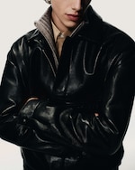 Placeholder for: Man in knitwear and black leather jacket