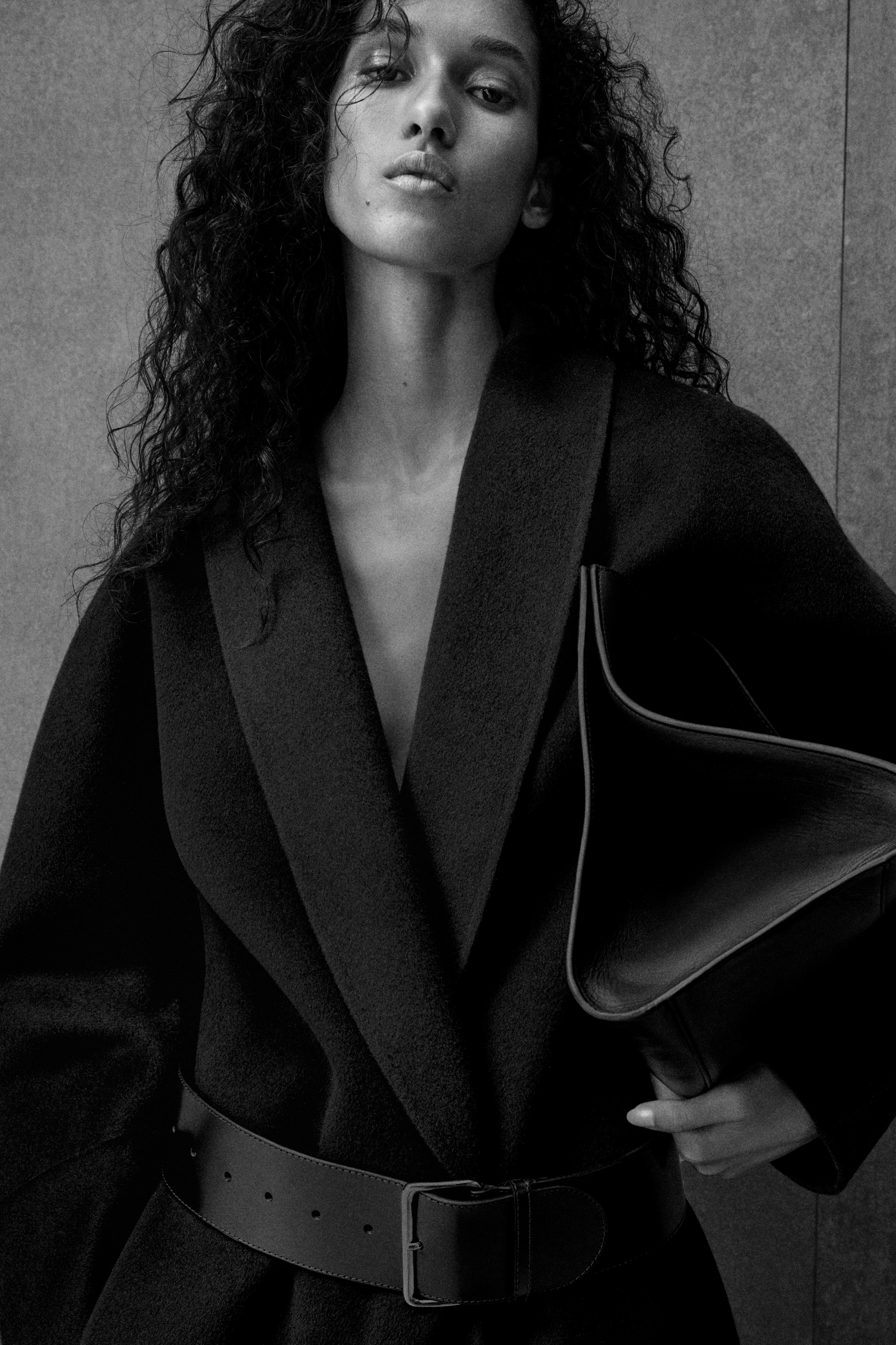 woman in coat holding bag