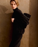 Placeholder for: Person wearing black holding bag