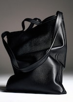 Placeholder for: A sleek black leather tote bag with two handles, positioned against a neutral background.